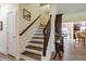Elegant staircase with wood railing and white risers, leading to the upper level of the home at 6916 Morrow Mill Road, Chapel Hill, NC 27516