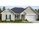 Charming single-story home featuring a two-car garage, neutral siding, and dark shutters at 71 Brodhead Dr, Fuquay Varina, NC 27526