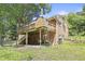 Elevated deck attached to a brick house, overlooking a spacious backyard with mature trees at 712 Beaver Dam Rd, Raleigh, NC 27607
