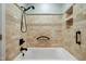 Tiled bathroom with a sleek, modern bathtub, hand shower, and convenient grab bar at 712 Beaver Dam Rd, Raleigh, NC 27607