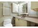 Bathroom featuring a sink with vanity and large mirror plus a modern, heated towel rack at 712 Beaver Dam Rd, Raleigh, NC 27607