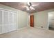 Bedroom featuring a ceiling design, large closet, and an adjoining bathroom with a tiled shower at 712 Beaver Dam Rd, Raleigh, NC 27607