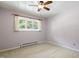 Bedroom featuring a large window offering natural light and neutral carpet at 712 Beaver Dam Rd, Raleigh, NC 27607