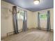 Bright bedroom featuring wood-look flooring, dual windows, and an ornate light fixture at 712 Beaver Dam Rd, Raleigh, NC 27607