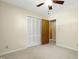 Bedroom with a ceiling fan, carpet flooring, and closet with a view into the hall at 712 Beaver Dam Rd, Raleigh, NC 27607