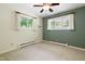 Bedroom with large windows providing natural light, complemented by neutral walls and carpet at 712 Beaver Dam Rd, Raleigh, NC 27607