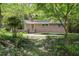 Charming brick home with a well-manicured front yard and mature trees at 712 Beaver Dam Rd, Raleigh, NC 27607