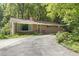 Well-maintained brick home with a driveway and lush landscaping, showcasing classic appeal at 712 Beaver Dam Rd, Raleigh, NC 27607
