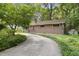 Charming brick home with a curved driveway and manicured landscaping, offering curb appeal at 712 Beaver Dam Rd, Raleigh, NC 27607