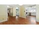 Open hallway showcasing hardwood floors and access to the living area and kitchen at 712 Beaver Dam Rd, Raleigh, NC 27607