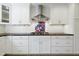 Beautiful kitchen with white cabinets, dark countertops, and a stylish range hood at 712 Beaver Dam Rd, Raleigh, NC 27607