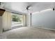 Bright living room featuring a large window, plush carpeting, and ceiling fan at 712 Beaver Dam Rd, Raleigh, NC 27607