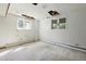 Spacious living room featuring dual windows for ample natural light and exposed ceiling at 712 Beaver Dam Rd, Raleigh, NC 27607