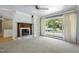 Inviting living room with a fireplace, built-in shelving, and scenic window view at 712 Beaver Dam Rd, Raleigh, NC 27607