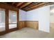 Cozy room with wood paneling and a glass door providing natural light at 712 Beaver Dam Rd, Raleigh, NC 27607
