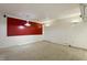 Bright living room featuring a retro red accent wall and overhead lighting at 712 Beaver Dam Rd, Raleigh, NC 27607