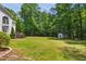 Backyard and shed are surrounded by lush greenery and mature trees at 7309 New Forest Ln, Wake Forest, NC 27587