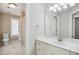 Bright bathroom with a toilet, sink, mirror, and doorway into another room at 7309 New Forest Ln, Wake Forest, NC 27587
