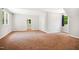 Large room with neutral walls, carpet, and a view to the backyard at 7309 New Forest Ln, Wake Forest, NC 27587