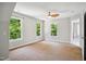 Well-lit bedroom with carpet, view to the exterior and a ceiling fan at 7309 New Forest Ln, Wake Forest, NC 27587