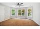 Bright bedroom with three windows, a ceiling fan and carpet at 7309 New Forest Ln, Wake Forest, NC 27587
