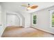 Bright bedroom with double doors, carpet and a ceiling fan at 7309 New Forest Ln, Wake Forest, NC 27587