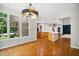 Inviting dining area with an open floor plan, hardwood floors, and large windows showcasing outdoor views at 7309 New Forest Ln, Wake Forest, NC 27587