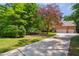 Brick home with attached two car garage and long driveway and beautiful mature landscaping at 7309 New Forest Ln, Wake Forest, NC 27587