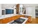 Modern kitchen with a stone countertop island, wood cabinets, stainless steel appliances, and an open layout at 7309 New Forest Ln, Wake Forest, NC 27587