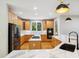 Spacious kitchen with wooden cabinets, stainless steel appliances, marble countertops, and modern pendant lights at 7309 New Forest Ln, Wake Forest, NC 27587