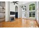 Living room features a stone fireplace, hardwood floors, and abundant natural light from large windows and doors at 7309 New Forest Ln, Wake Forest, NC 27587