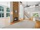 Open-concept living room with fireplace, wood floors, blue accent wall, and ample natural light at 7309 New Forest Ln, Wake Forest, NC 27587