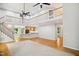 Expansive living room with hardwood floors, a staircase, an upper level balcony, and natural light at 7309 New Forest Ln, Wake Forest, NC 27587