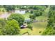 Aerial view of estate featuring a private pond, mature trees, and ample acreage at 771 Cedar Grove Church Rd, Roxboro, NC 27574