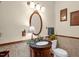 Elegant bathroom with an oval mirror, decorative lamp, and hexagonal-patterned floor tiles at 771 Cedar Grove Church Rd, Roxboro, NC 27574