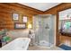 Bathroom featuring custom wood trim, marble floors, tub and shower, nice decor and furnishings at 771 Cedar Grove Church Rd, Roxboro, NC 27574