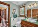 Bathroom with green countertop, tile and trim, wooden accents and access to shower at 771 Cedar Grove Church Rd, Roxboro, NC 27574