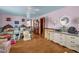 Cozy bedroom featuring hardwood floors, two beds, dresser, and a chair for comfort at 771 Cedar Grove Church Rd, Roxboro, NC 27574