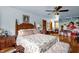 Inviting bedroom featuring hardwood floors, a large bed, and access to closet space at 771 Cedar Grove Church Rd, Roxboro, NC 27574