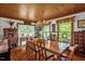 Charming dining room with a large wooden table, chandelier, and natural light at 771 Cedar Grove Church Rd, Roxboro, NC 27574