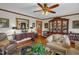 Living room showcasing hardwood floors, a decorative mirror, and comfortable armchair at 771 Cedar Grove Church Rd, Roxboro, NC 27574