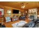 Comfortable living room with stone fireplace, hardwood floors, and custom decor and furnishings at 771 Cedar Grove Church Rd, Roxboro, NC 27574