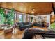 Comfortable living room featuring a wood ceiling, hardwood floors and large windows at 771 Cedar Grove Church Rd, Roxboro, NC 27574