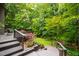 Stairs from the backyard deck lead to a beautiful, lush landscaped lawn at 7816 Harbor Dr, Raleigh, NC 27615