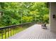 A spacious backyard deck overlooks a lush green forest at 7816 Harbor Dr, Raleigh, NC 27615