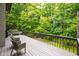 Relax on the outdoor deck surrounded by a beautiful lush green forest at 7816 Harbor Dr, Raleigh, NC 27615