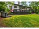 Expansive backyard featuring a lush lawn, a large deck, and steps to the yard at 7816 Harbor Dr, Raleigh, NC 27615