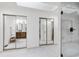 Bathroom showcasing a glass door walk-in shower, tiled floors and view to the double vanity at 7816 Harbor Dr, Raleigh, NC 27615