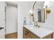 Bathroom features a wood vanity, white countertop, and an oval mirror at 7816 Harbor Dr, Raleigh, NC 27615
