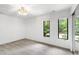 Minimalist bedroom with neutral carpet, bright walls and two large windows for natural light at 7816 Harbor Dr, Raleigh, NC 27615